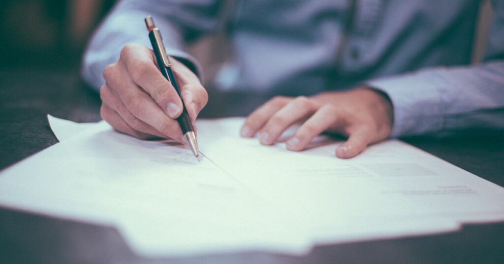 Person signing a will document - estate planning